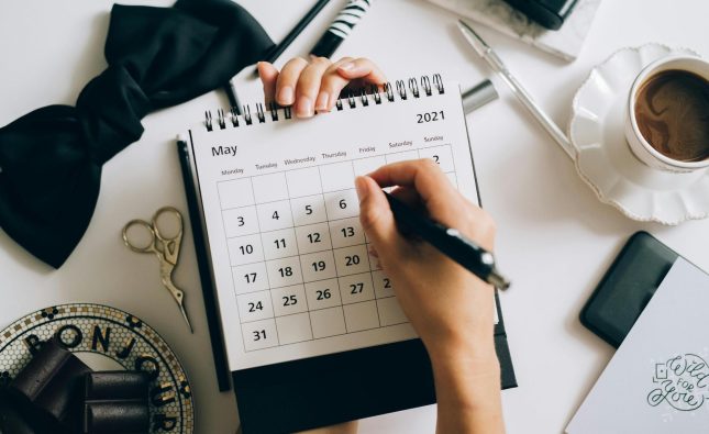  Organized desk with a family health calendar and more for scheduling household appointments.